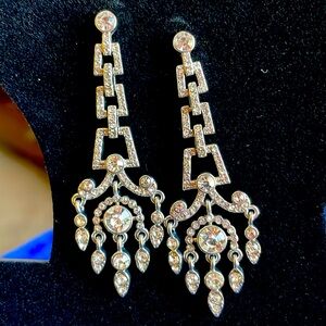 Silver tone crystal drop pierced earrings.